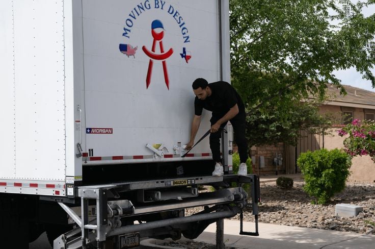 a member of Moving By Design opening a truck