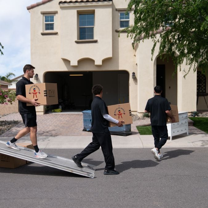 members of Moving By Design unloading items from a truck