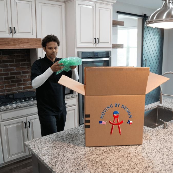 a member of Moving By Design packing things