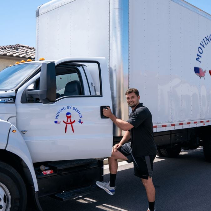 a member of Moving By Design entering a truck