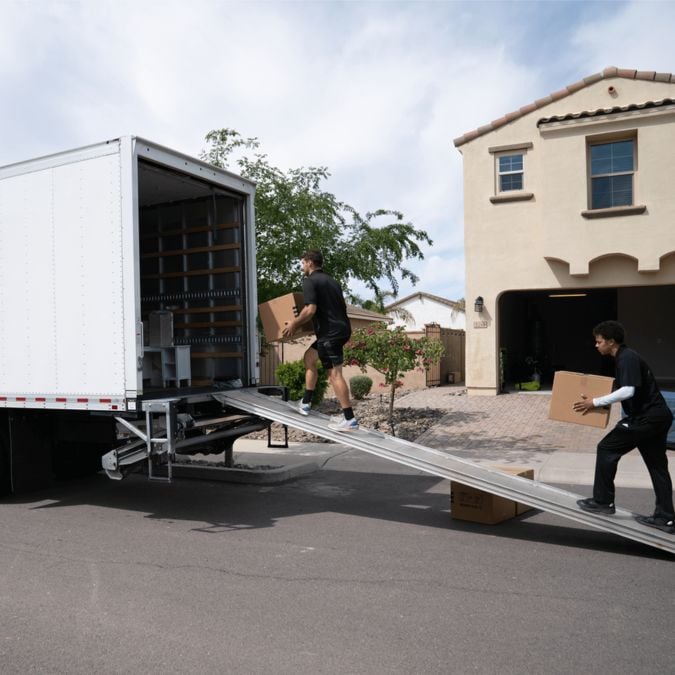 members of Moving By Design loading boxes