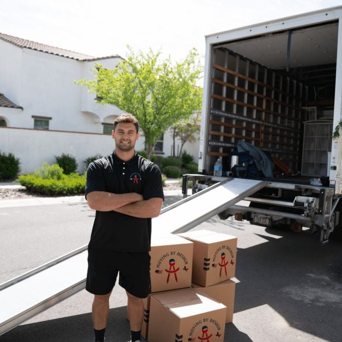 a member of Moving By Design in front of their truck