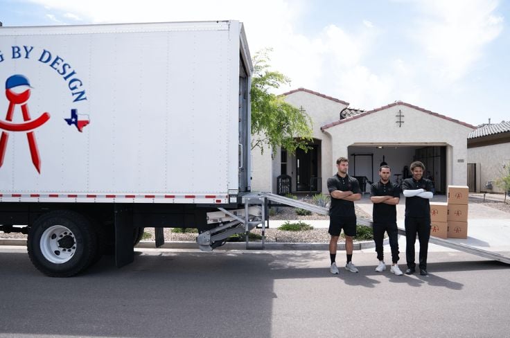 Moving By Design members in front of their truck